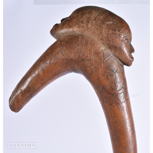 372 - AN UNUSUAL AFRICAN TRIBAL DOUBLE HEADED THROWING CLUB with engraved motifs. 60 cm long,
