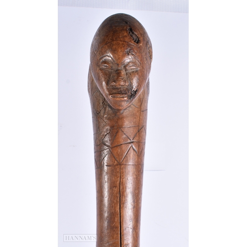 372 - AN UNUSUAL AFRICAN TRIBAL DOUBLE HEADED THROWING CLUB with engraved motifs. 60 cm long,