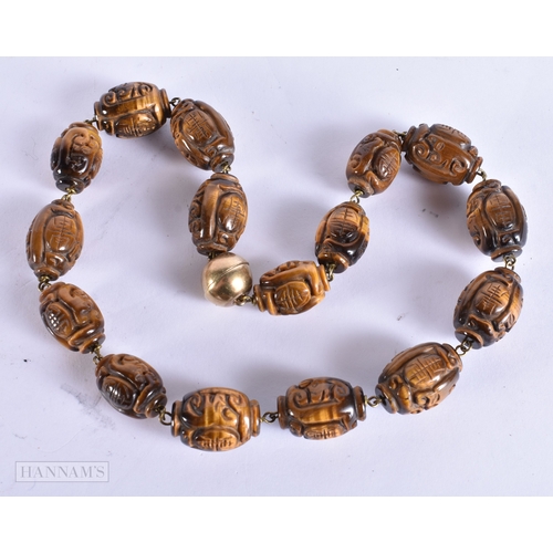 374 - A FINE LATE 19TH/20TH CENTURY SILVER MOUNTED TIGERS EYE NECKLACE Late Qing. 44 cm long.