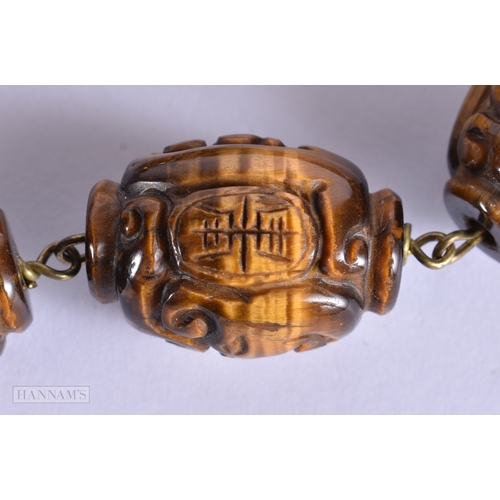 374 - A FINE LATE 19TH/20TH CENTURY SILVER MOUNTED TIGERS EYE NECKLACE Late Qing. 44 cm long.