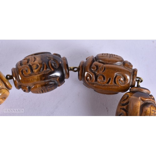 374 - A FINE LATE 19TH/20TH CENTURY SILVER MOUNTED TIGERS EYE NECKLACE Late Qing. 44 cm long.