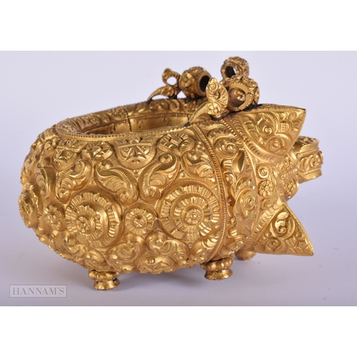 384 - A LARGE ANTIQUE INDIAN YELLOW METAL WEDDING CEREMONIAL BANGLE. 692 grams. Internal width 6.25 cm.