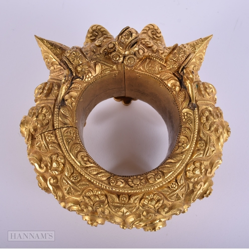384 - A LARGE ANTIQUE INDIAN YELLOW METAL WEDDING CEREMONIAL BANGLE. 692 grams. Internal width 6.25 cm.