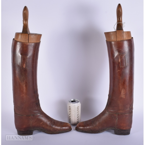 409 - A vintage pair of Riding boots together with a Alkit wooden lasts 56cm.