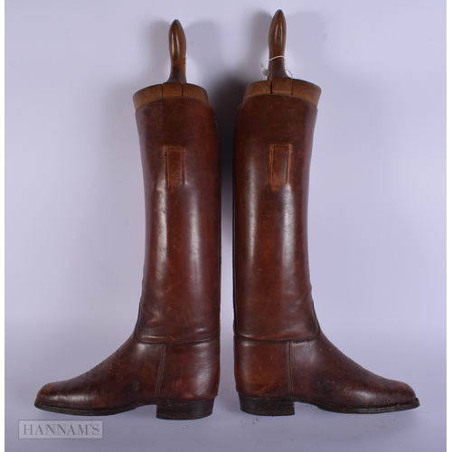 409 - A vintage pair of Riding boots together with a Alkit wooden lasts 56cm.