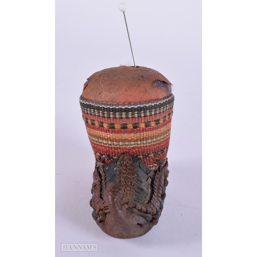 472 - AN ANTIQUE CONTINENTAL LEATHER EMBROIDERED PIN CUSHION. 9 cm x 5.5 cm.