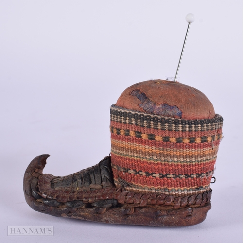 472 - AN ANTIQUE CONTINENTAL LEATHER EMBROIDERED PIN CUSHION. 9 cm x 5.5 cm.