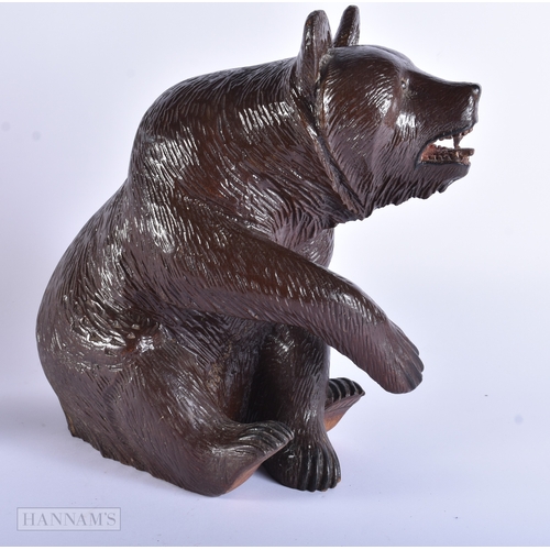 58 - A LARGE EARLY 20TH CENTURY BAVARIAN BLACK FOREST CARVED WOOD BEAR modelled with one arm raised. 32 c... 