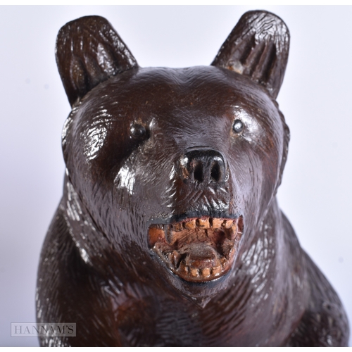 58 - A LARGE EARLY 20TH CENTURY BAVARIAN BLACK FOREST CARVED WOOD BEAR modelled with one arm raised. 32 c... 