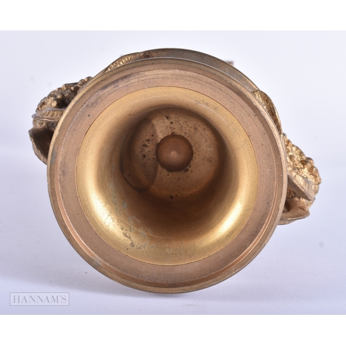 7 - A 19TH CENTURY FRENCH GILT BRONZE AND MARBLE URN decorated with mask heads. 24.5 cm high.