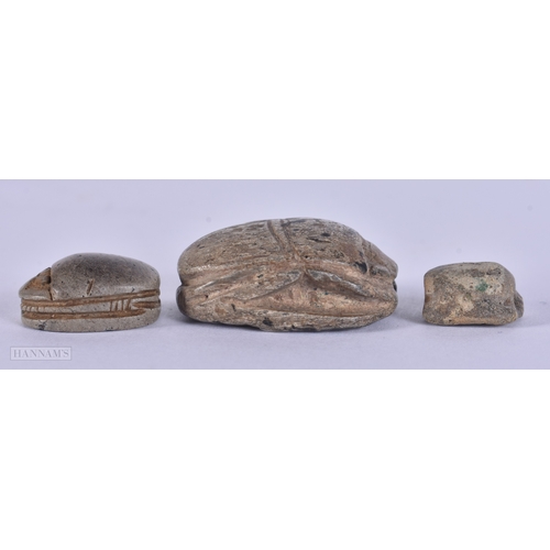 105 - TWO ANTIQUE EGYPTIAN CARVED STONE SCARAB BEETLES together with another similar item. Largest 3.25 cm... 