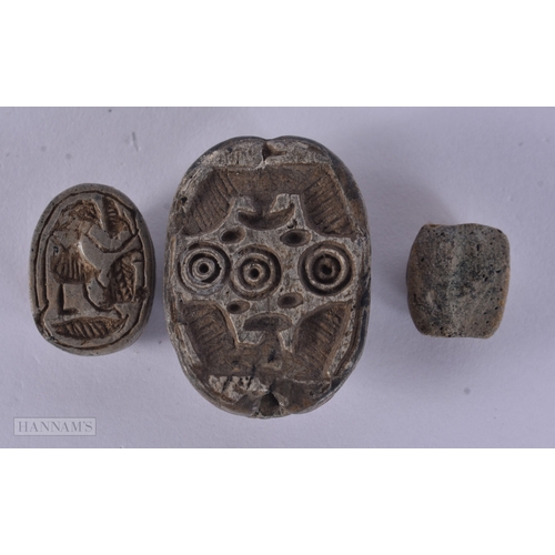 105 - TWO ANTIQUE EGYPTIAN CARVED STONE SCARAB BEETLES together with another similar item. Largest 3.25 cm... 