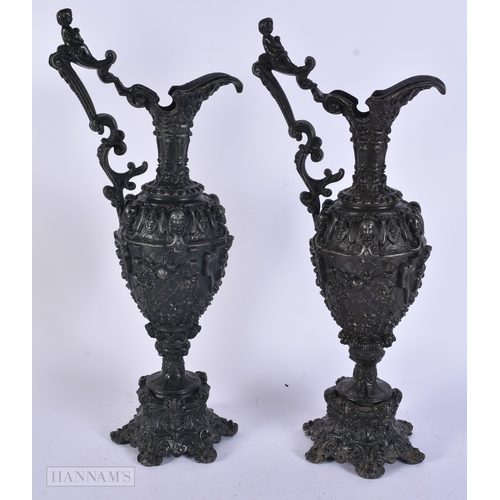 11 - A PAIR OF VICTORIAN CAST METAL CANDLESTICK HOLDERS together with a plated tankard. Largest 38 cm hig... 