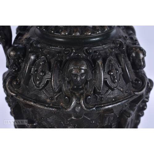 11 - A PAIR OF VICTORIAN CAST METAL CANDLESTICK HOLDERS together with a plated tankard. Largest 38 cm hig... 