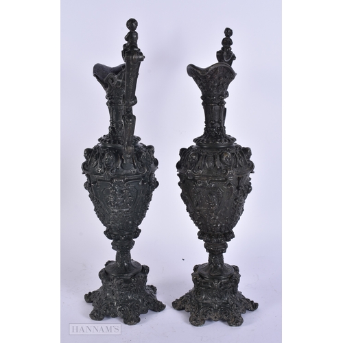 11 - A PAIR OF VICTORIAN CAST METAL CANDLESTICK HOLDERS together with a plated tankard. Largest 38 cm hig... 