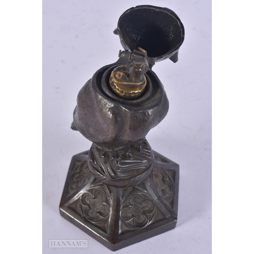 13 - A RARE ANTIQUE NOVELTY SPELTER OWL LIGHTER with glass eyes. 13.5 cm high.