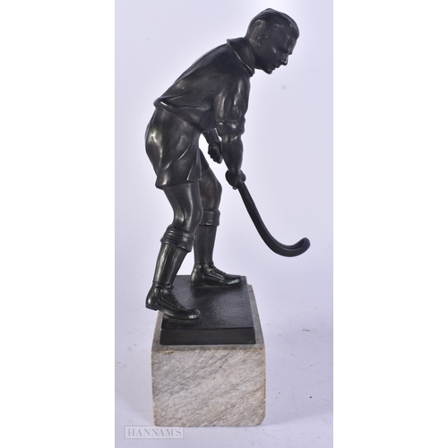 17 - AN UNUSUAL ART DECO SPELTER HOCKEY PLAYER modelled upon a marble base. 24.5 cm high.