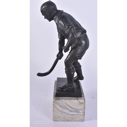 17 - AN UNUSUAL ART DECO SPELTER HOCKEY PLAYER modelled upon a marble base. 24.5 cm high.
