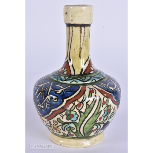 38 - A MIDDLE EASTERN ISLAMIC IZNIK STYLE POTTERY VASE. 13 cm high.