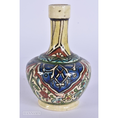 38 - A MIDDLE EASTERN ISLAMIC IZNIK STYLE POTTERY VASE. 13 cm high.
