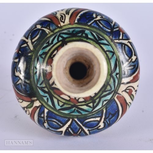 38 - A MIDDLE EASTERN ISLAMIC IZNIK STYLE POTTERY VASE. 13 cm high.