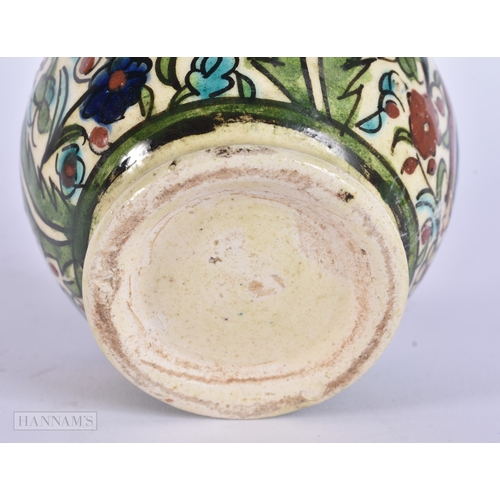 38 - A MIDDLE EASTERN ISLAMIC IZNIK STYLE POTTERY VASE. 13 cm high.
