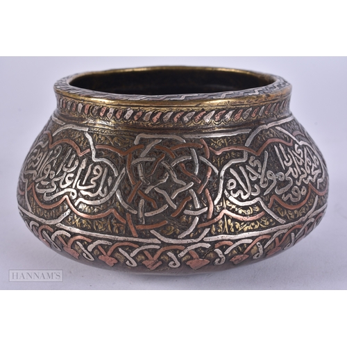 49 - A 19TH CENTURY ISLAMIC MIDDLE EASTERN SILVER INLAID CENSER decorated with scripture. 12 cm wide.