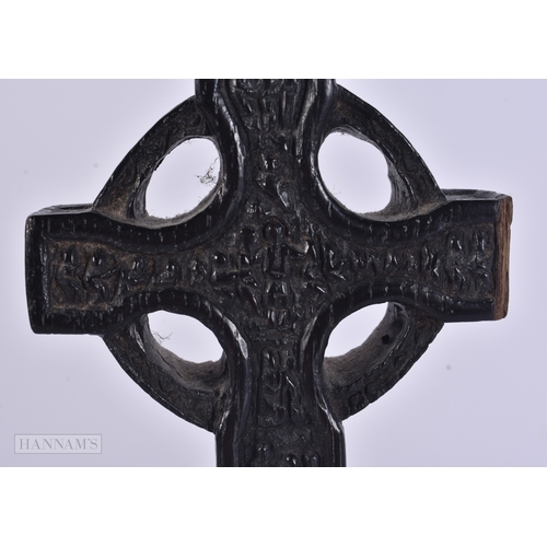 53 - AN EARLY IRISH CARVED BOG OAK CRUCIFIX. 21 cm high.