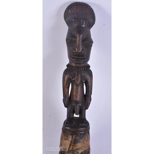 54 - TWO AFRICAN TRIBAL CARVED WOOD FIGURES. Largest 59 cm long inc material. (2)