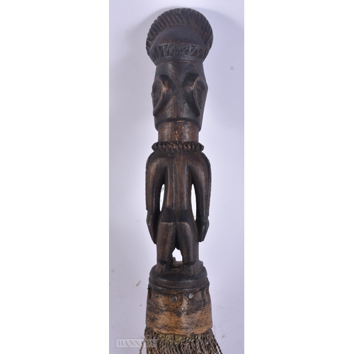 54 - TWO AFRICAN TRIBAL CARVED WOOD FIGURES. Largest 59 cm long inc material. (2)