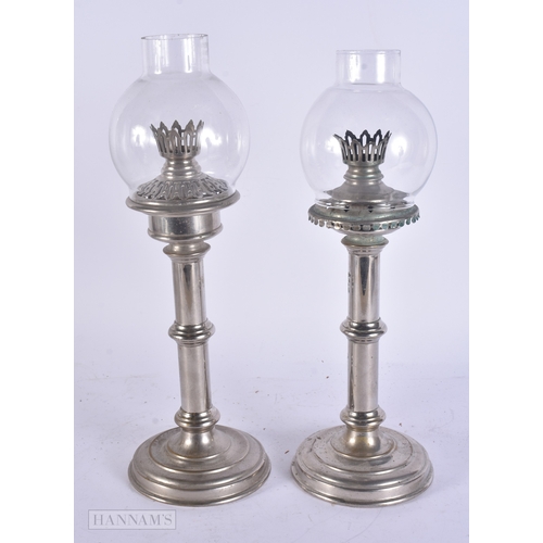 63 - AN UNUSUAL ANTIQUE TIN CASED SILVER PLATED CAMPAIGN TRAVELLING OIL LAMPS. Case 55 cm x 27 cm.