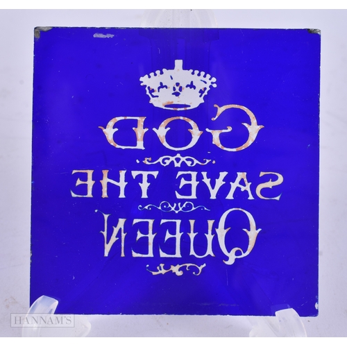68 - A VICTORIAN/EDWARDIAN BRISTOL BLUE GLASS GOD SAVE THE QUEEN PLAQUE. 8.25 cm square.