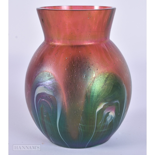 81 - AN IRIDESCENT GLASS PEACOCK FEATHER SWIRL VASE. 10.5 cm x 8.5 cm.