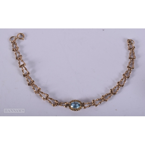 1133 - 9ct gold blue topaz set gate bracelet.  17cm long (2.8g)
