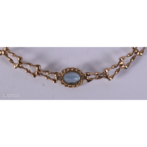 1133 - 9ct gold blue topaz set gate bracelet.  17cm long (2.8g)