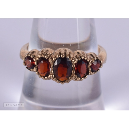 1134 - 9ct gold vintage garnet set five stone ring.  Size N (2.4g)