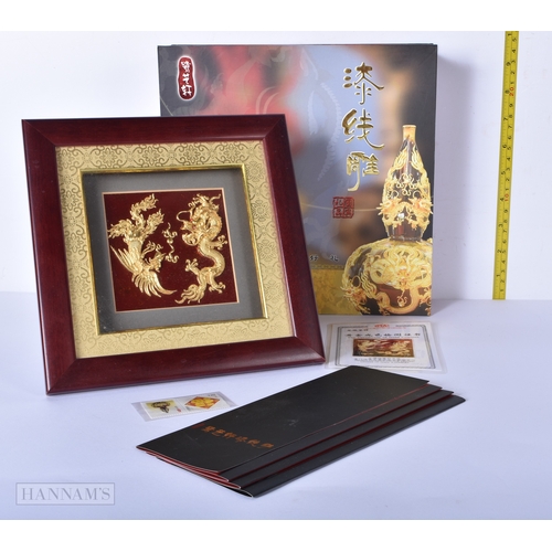 3028 - A boxed framed gold leaf  sculpture of dragons with a 99% golf content together with lacquered dishe... 