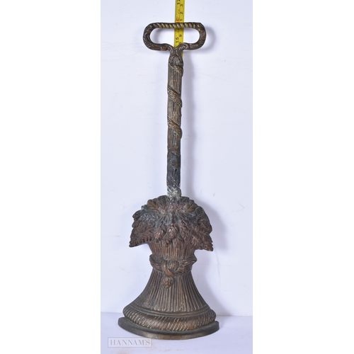 3038 - An antique brass wheatsheaf door stop 41cm.