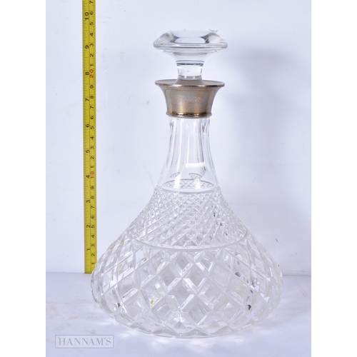 3043 - A silver rimmed cut glass ships decanter 25cm