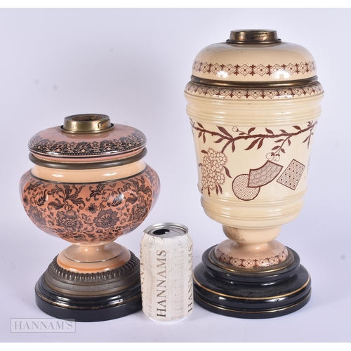 315 - TWO ANTIQUE STONEWARE POTTERY OIL LAMPS. Largest 35 cm high. (2)