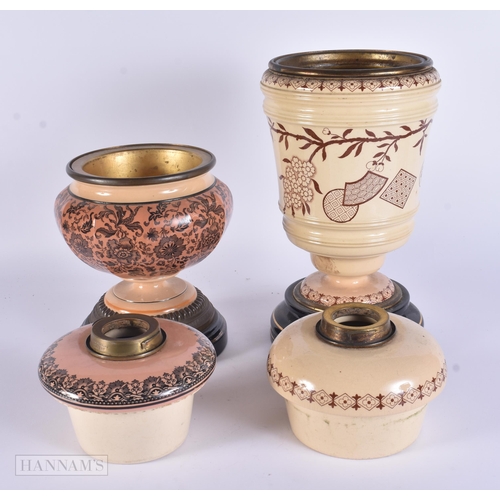 315 - TWO ANTIQUE STONEWARE POTTERY OIL LAMPS. Largest 35 cm high. (2)