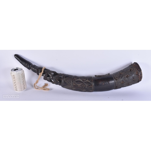 317 - A LARGE AFRICAN TRIBAL CARVED WOOD OLIPHANT. 62 cm long.