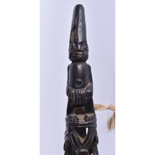 317 - A LARGE AFRICAN TRIBAL CARVED WOOD OLIPHANT. 62 cm long.