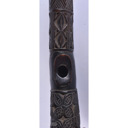 317 - A LARGE AFRICAN TRIBAL CARVED WOOD OLIPHANT. 62 cm long.