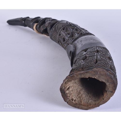 317 - A LARGE AFRICAN TRIBAL CARVED WOOD OLIPHANT. 62 cm long.