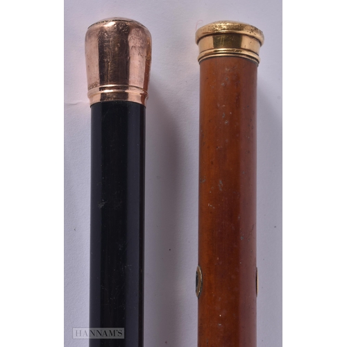 324 - AN ANTIQUE 9CT GOLD MOUNTED WALKING CANE together with a yellow metal cane. 89 cm long. (2)