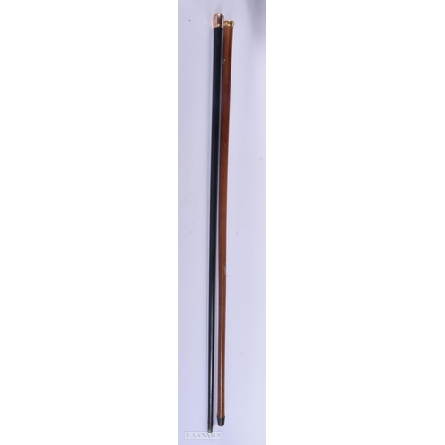 324 - AN ANTIQUE 9CT GOLD MOUNTED WALKING CANE together with a yellow metal cane. 89 cm long. (2)