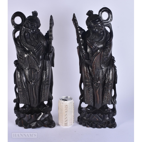 340 - A PAIR OF 19TH CENTURY CHINESE CARVED SILVER INLAID HARDWOOD FIGURES. 48 cm high.