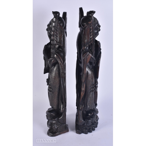 340 - A PAIR OF 19TH CENTURY CHINESE CARVED SILVER INLAID HARDWOOD FIGURES. 48 cm high.
