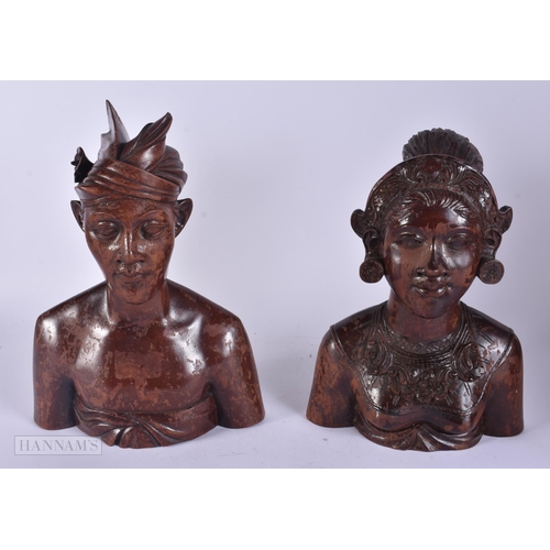 343 - A PAIR OF SOUTHEAST ASIAN WOODEN BUSTS. 30 cm x 15 cm.